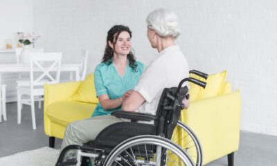 smiling-woman-looking-senior-woman-sitting-wheel-chair_tn